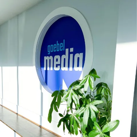 The Goebel Media wall logo in the sunlit studio entry