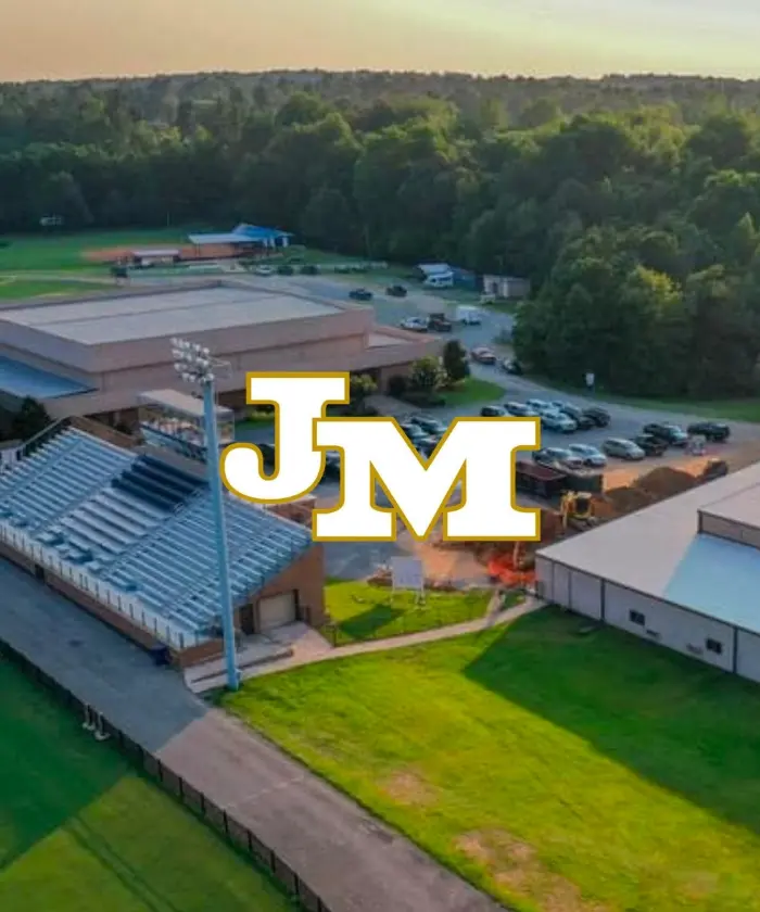 The John Milledge Academy monogram over an aerial view of the school's campus and fields