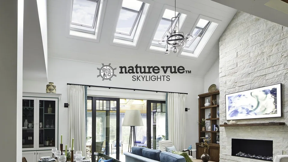 A vaulted living room lit by Nature Vue skylights, with the Nature Vue logo