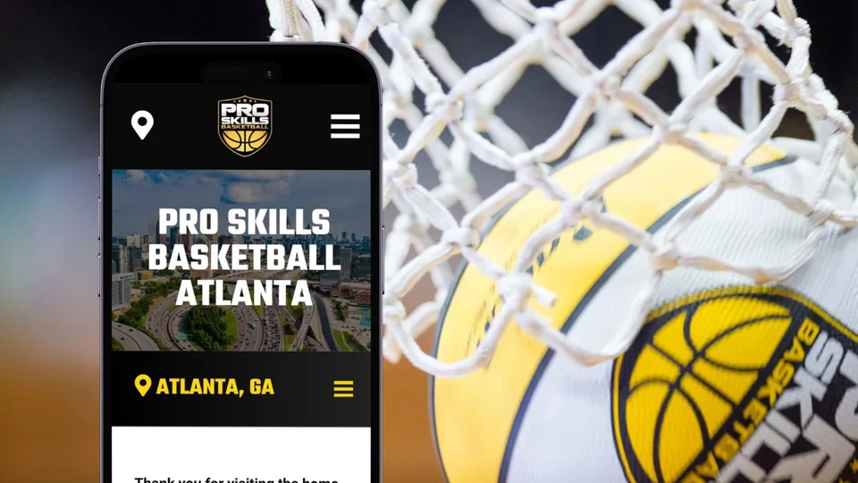 The Pro Skills Basketball Atlanta site on a phone beside a ball going through the net