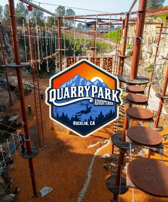 The Quarry Park Adventures logo over the park's ropes course built into a quarry wall