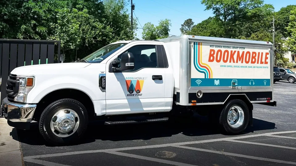 The library system's bookmobile wrapped in the new brand identity