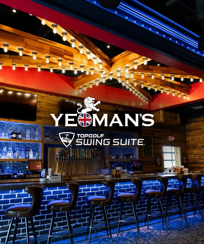 The Yeoman's Topgolf Swing Suite logo over the bar's blue-lit brick counter